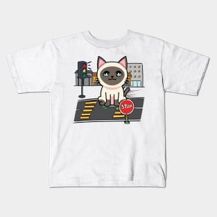 Cute Siamese cat is skate boarding on the street Kids T-Shirt